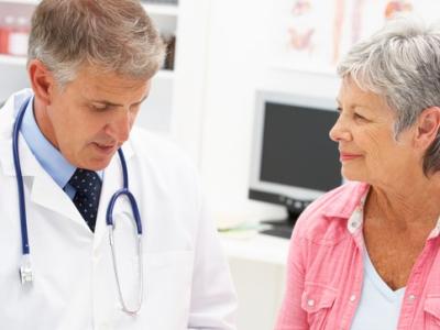 Older doctor writing prescription