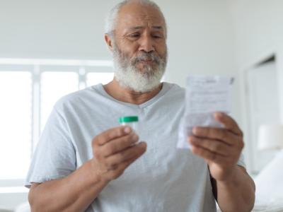 Older man reading prescription