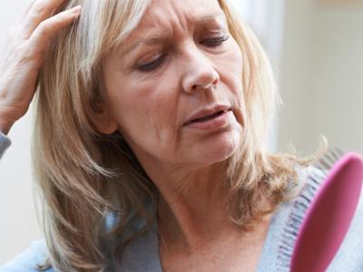 Older woman checking for hair loss