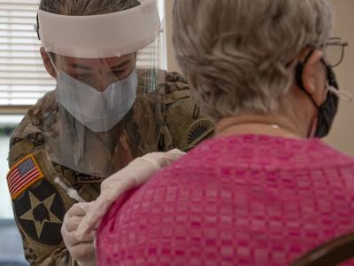 Older woman receiving COVID-19 vaccine