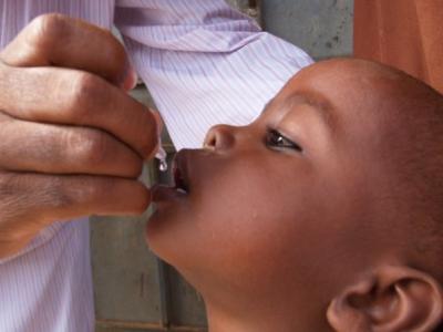 Child receiving oral polio vaccine