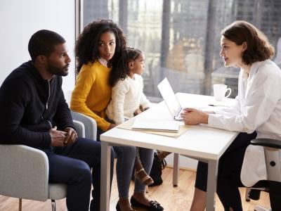 Pediatrician consulting with parents