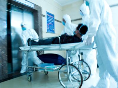 Patient being rushed through hospital on gurney