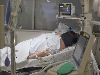 Patient lying prone in hospital bed