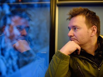 thoughtful man looking out train window