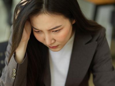 Pensive woman at laptop