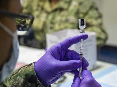 Pfizer COVID vaccine vial drawing into syringe