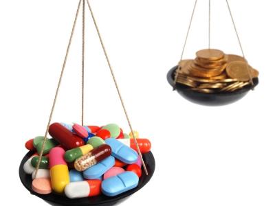 Pills and coins on a scale