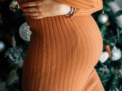 Pregnant woman in front of Christmas tree