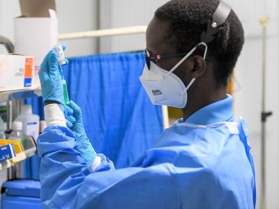 Healthcare worker preparing a COVID booster dose