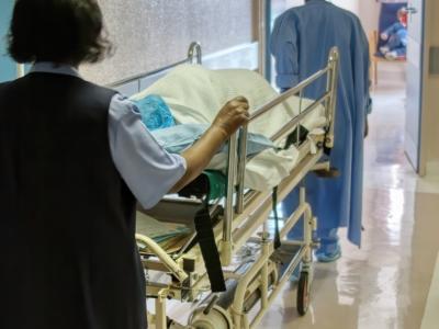 Pushing gurney in hospital hallway