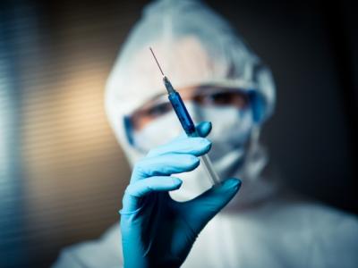 Researcher with syringe