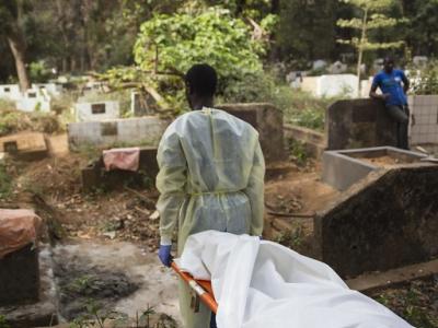 Ebola body on stretcher at cemetary
