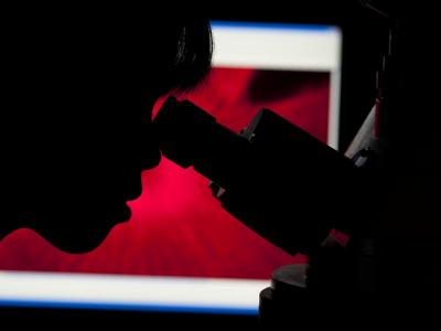 Scientist with microscope