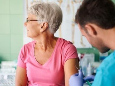 Senior being vaccinated