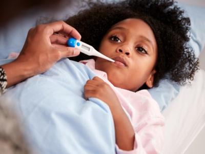 Sick girl with thermometer