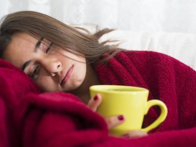 Sick woman with mug of tea