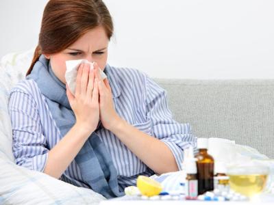 Sick woman blowing nose