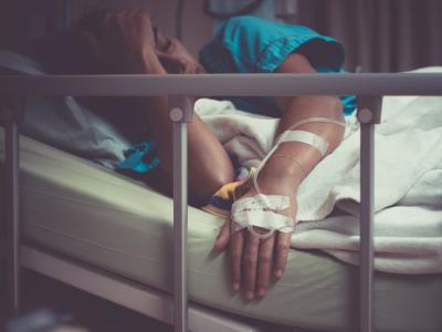 Sick woman in hospital bed