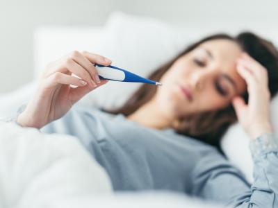 Sick woman taking temp