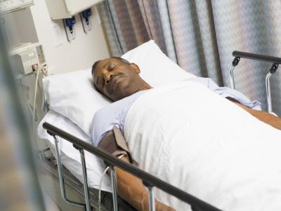 Sleeping black man in hospital bed