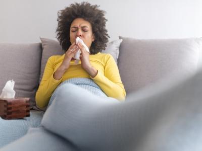 Woman sneezing with facial tissues