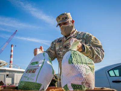 Soldier with frozen turkeys