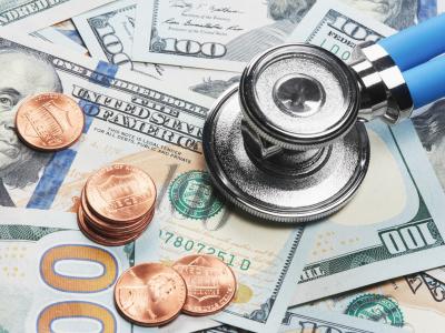 Stethoscope on a pile of money