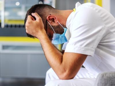 Stressed healthcare worker wearing mask