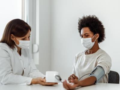 Taking woman's blood pressure