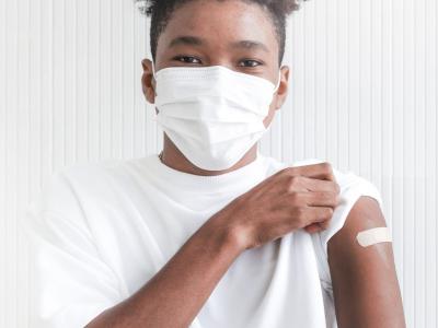 Teen boy with post-vaccine bandaid