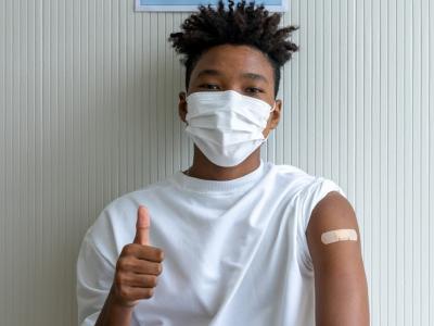 Teen with thumbs-up after vaccination