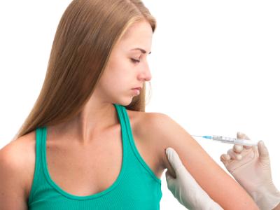 Teen receiving vaccine