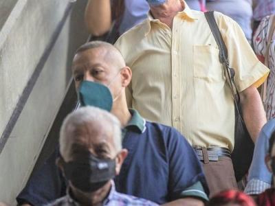 Train commuters inside station wearing masks