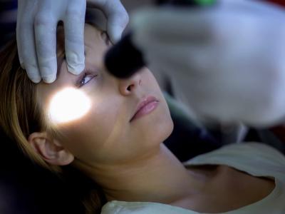 Pupil flashlight test on unconscious girl