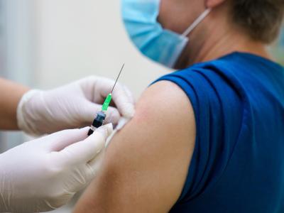 Preparing man's arm for vaccination