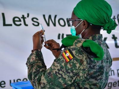 Vaccine worker with vial and syringe