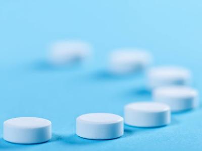 White pills blue background