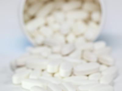 White pills spilling from container