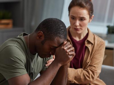 Woman comforting depressed man