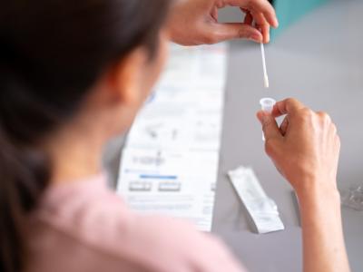 Woman conducting COVID-19 self-test