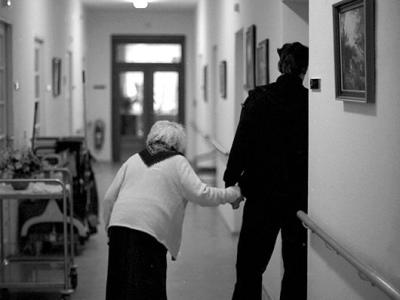 Woman being escorted in nursing home