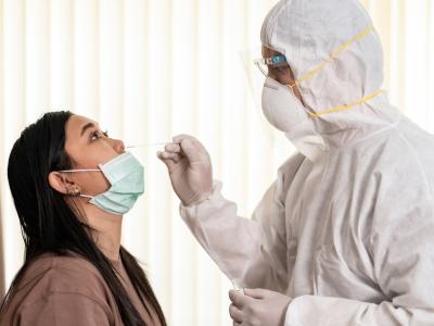 Woman with mask down getting nasal swab