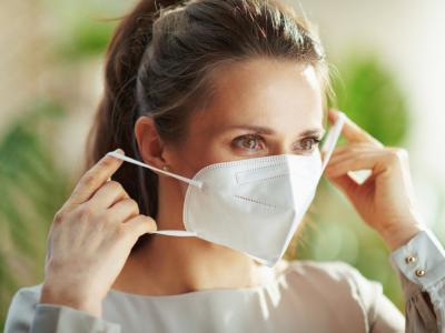 Woman putting on a respirator