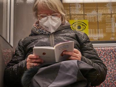 Woman reading and wearing N95 respirator