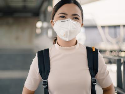 Woman wearing respirator in airport