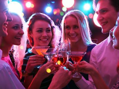 Young adults clinking drinks