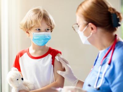 Young boy in mask after vaccination