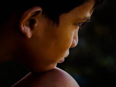 Young boy with chin on knee