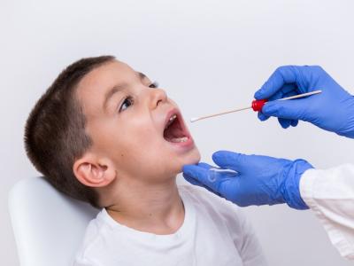 Young boy getting a throat swab
